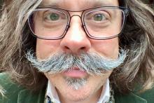Jeffrey A. McGuire behind comedy mustache