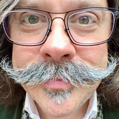 Jeffrey A. McGuire behind comedy mustache